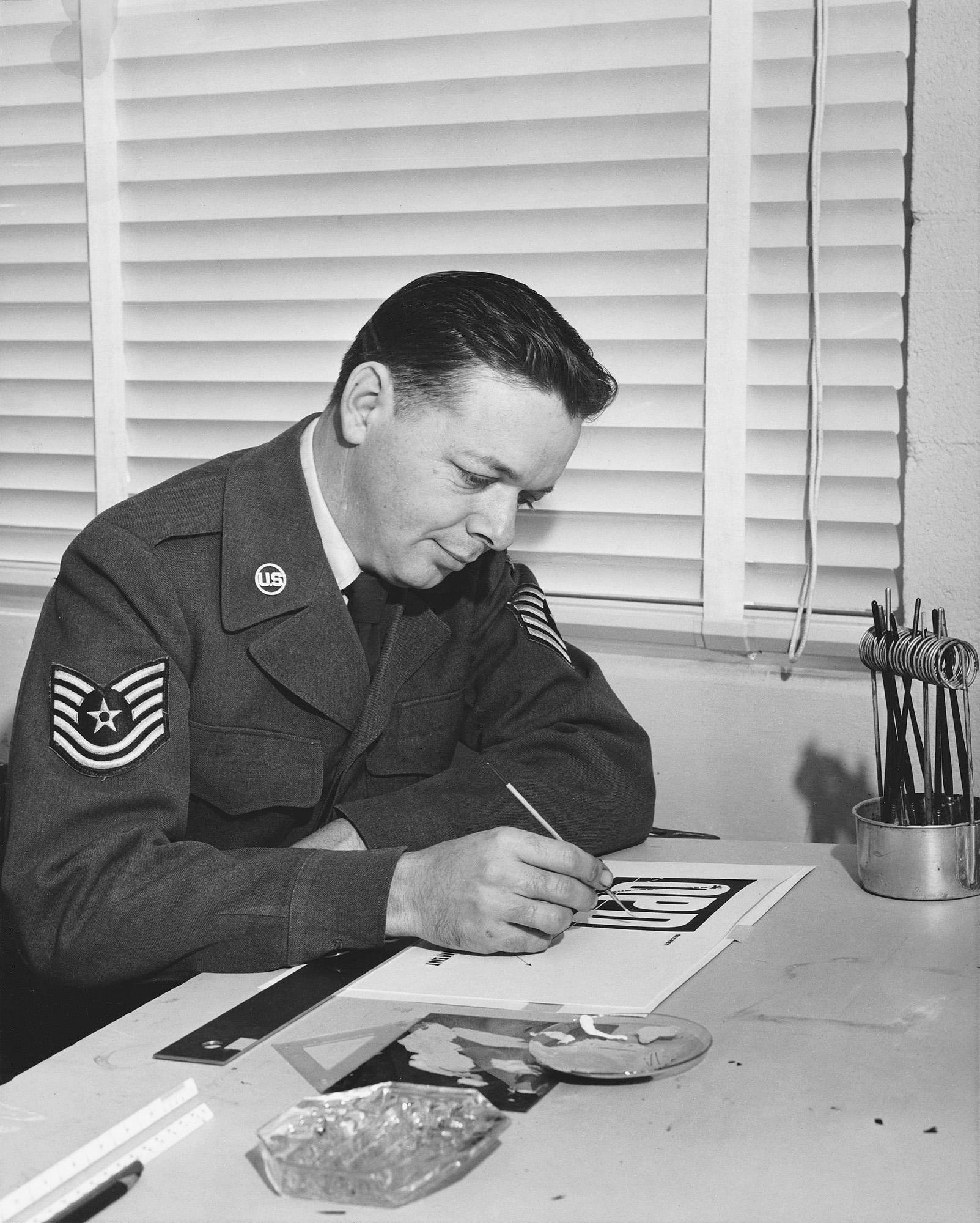 Another photo of my Father, Gordon Clevenger, working at his desk at Edwards AFB, circa 1962. He designed a lot of things for the Air Force, including some he couldn't tell us about, but he also designed various brochures, ads, and booklets for the military, including a few of his Commanding Officer's annual Christmas Cards. View full size.