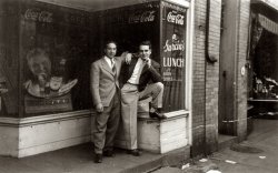 Dad (right) and his friend Gigi (John) Gori standing outside the beer garden run by Gigi's sister Toni in downtown Wilson, PA. I believe this photograph was taken in 1939 shortly before they joined the Marine Corps in January 1940. If so, they would have been 18 years old. In the fall of 1939, Gigi and Dad decided that they would join the Army. So they made it down to the recruiting station in Pittsburgh. For some reason Gigi was not allowed in. So much for that plan until they saw a recruiting poster for the Marines. The poster showed a Marine in dress blues sitting on a horse. Both signed up.
(ShorpyBlog, Member Gallery)