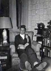 This is my dad at age 18, shortly before mustering out for the Army, circa 1951. This shot was taken in the family living room in Troy, NY. Dad's smoking a pipe (probably my grandfather's) and is wearing an ascot, a robe, striped silk socks, and is surrounded by the 'finest' literature at that time - Reader's Digest condensed editions (again, my grandfather's). Just for the record, my family was not wealthy, but was in the apparel business - so everyone was well-dressed and well-shod, if nothing else.
It's weird for me to look at this photo, and think of my Dad presently, still sitting in an easy chair, at age 76, still reading books, still wearing his robe. View full size.
(ShorpyBlog, Member Gallery)