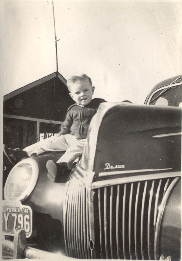 My dad on his dad's Ford DeLuxe, around 1942. 
