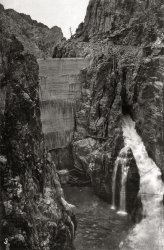 Can anyone identify this dam?  This photo is one of a trio purchased in northern California.  I get dizzy just looking at the staircases clinging to the side of the cliff on the right. View full size.