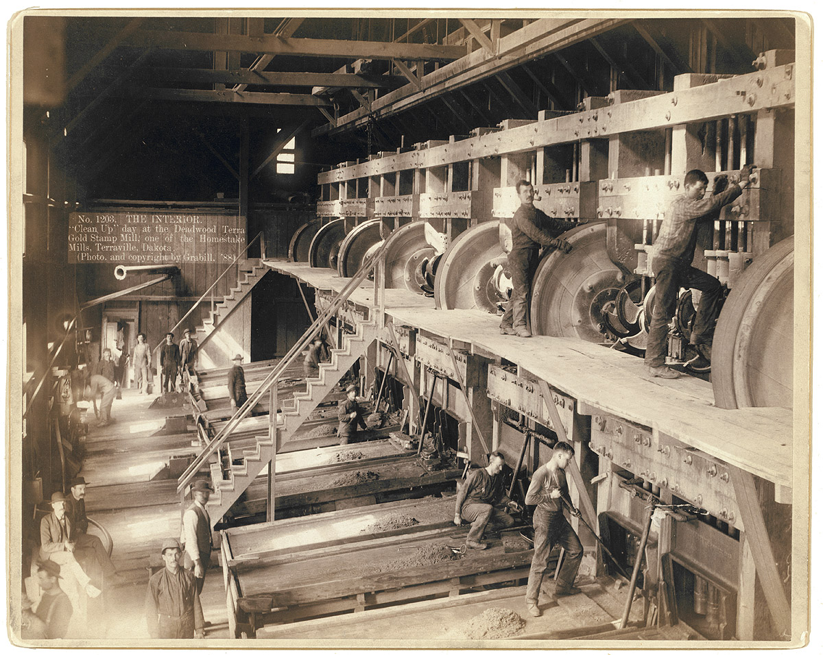 "Clean Up Day" at the Deadwood Terra Gold Stamp Mill near Terraville in the Dakota Territory. Ore fed into the mill is stamped, or crushed, to prepare it for the chemical extraction of gold. Photograph by John C.H. Grabill. View full size.