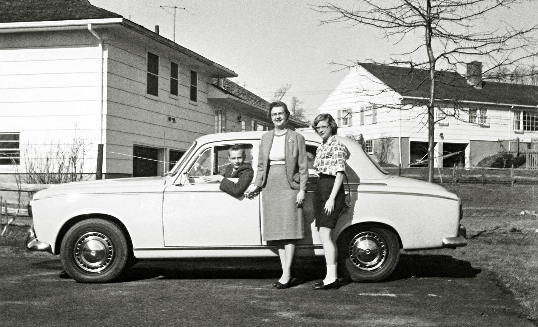 Dad got this Peugeot as a commuter car to travel from our house in Chatham to Union, New Jersey each day. It had radial tires and a sun roof. With me at the wheel and Mom and sister. View full size.