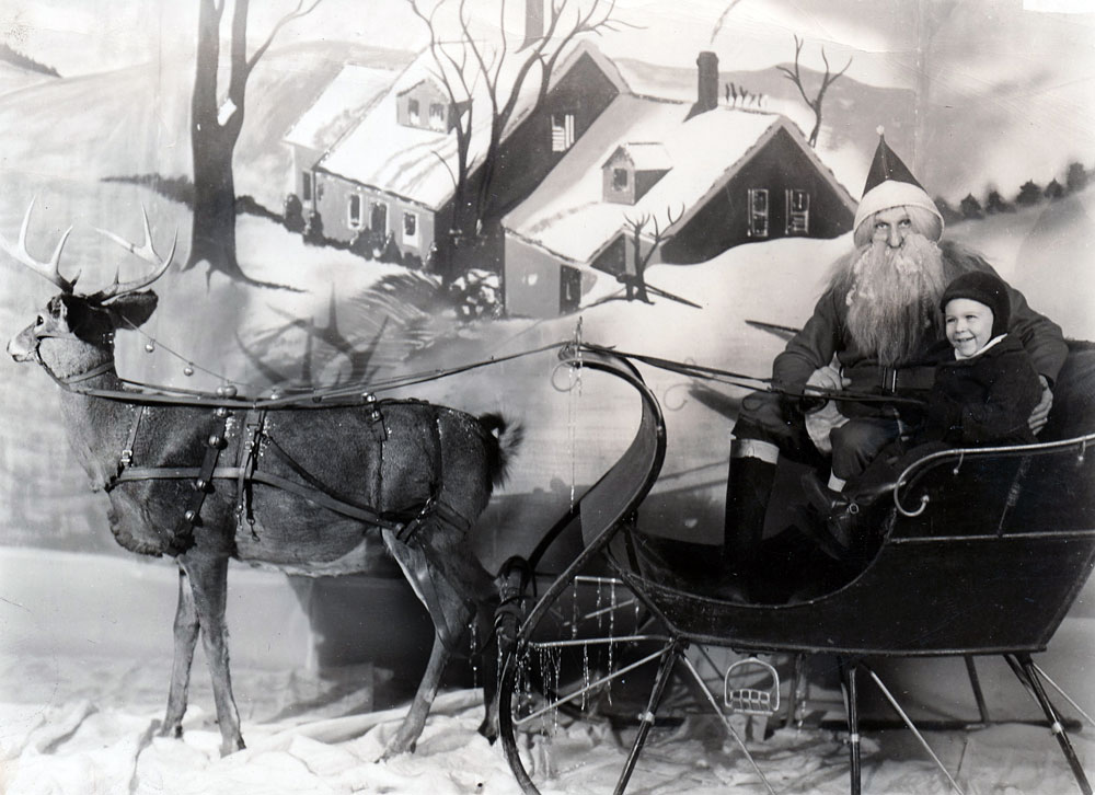 Posing with Santa Claus and reindeer at Kresge's Department Store in Lafayette, Indiana, 1947. View full size.