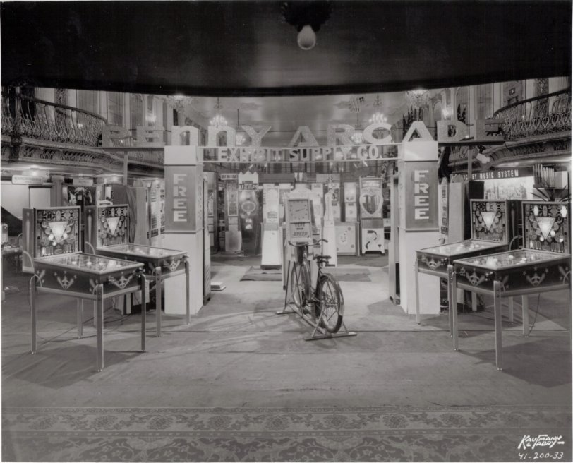 If you are a fan of old arcade machines, this photo is for you. It is a wonderful trade show display from 1941. Probably in a ball room in some old Chicago Hotel. 
Front and center, Exhibit Supply was a well known amusement device manufacturer for many decades. Pinball, postcard vendors and personality testers were just some of the machines they made. If you look carefully there are some other manufacturers along the sides of the room including Metropolitan Amusement Co. and Holly Mfg Co. A music system manufacturer is visible but the name is partially obscured by some of the other machines.
This original 8x10 print was purchased from Dick Bueschel, an author who wrote many books in the coin-op field. I was fortunate enough to buy several great images from Dick before he died in 1998. View full size.
