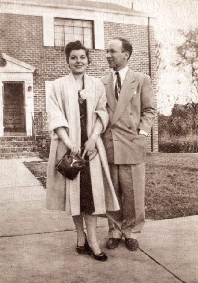 My (future) mother and father stand in front of their first home, a “garden apartment” in New Brunswick, New Jersey during the first year after they were wed. What I like about this picture is how very I Love Lucy their clothing is, and how much like a model (that she was way too short to ever be) my mother stands. Having her two parents in the garment trade, she saw the whole universe through a filter of fashion. That she got my father to dress so spiffy mystifies me. He was never again the fashionable sort that this photograph makes him seem to be. Scan was made from a print. View full size. 
