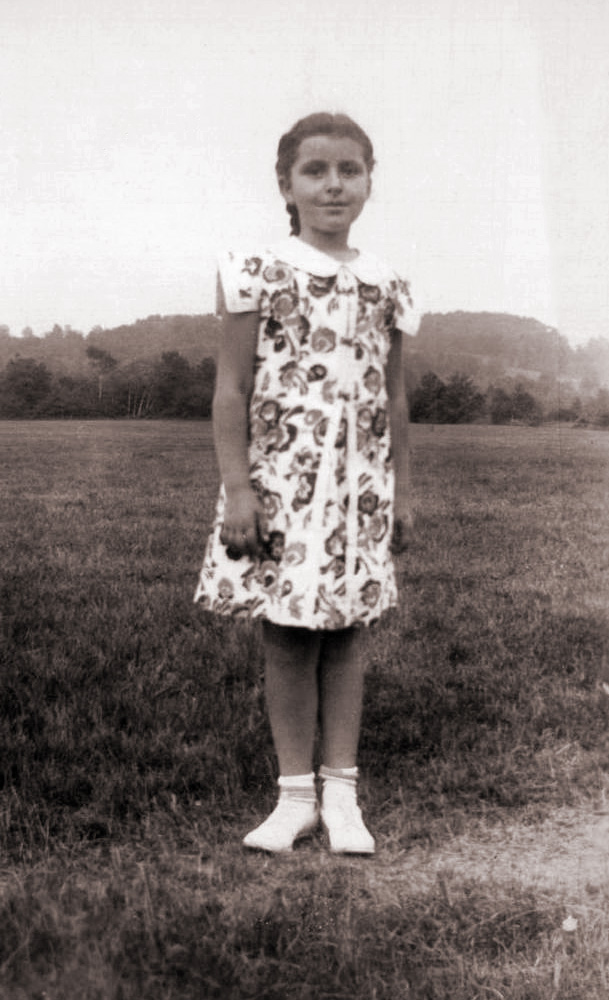My future mother, who was then seven years old, stands alone in a field to have her picture taken, probably during a family vacation at a Catskills New York resort. She had flame red hair as a child, and is wearing a dress with very odd sleeves.
Who took the picture is unknown. Scan was made from a print. View full size.