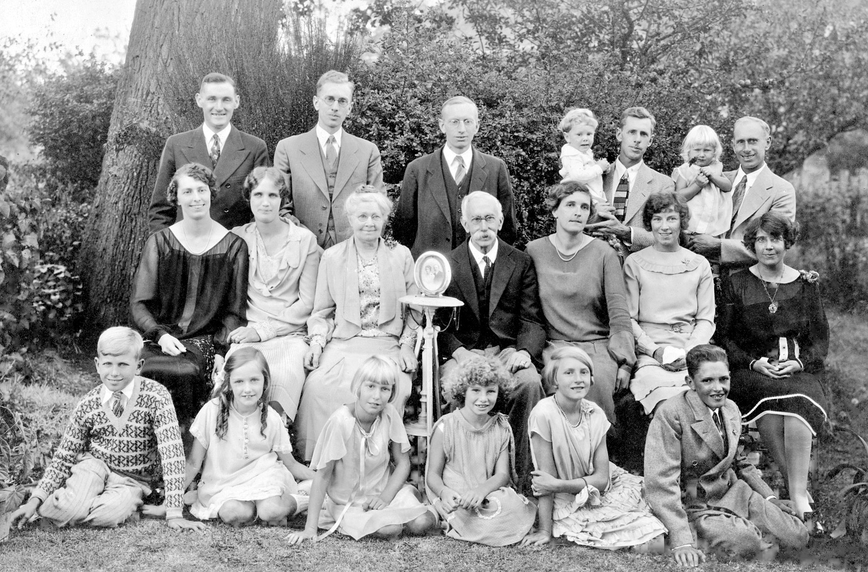 This is a portrait of my mother’s side of the family, taken about 1927. That’s her in the top right corner, at about the age of one, being held by my grandfather. My grandmother is in the dark dress, seated directly in front of them. Across the back row are my great-uncles, whom I don’t know too much about except that one of them suffered from “shell shock” during the Great War and was never the same afterward. I think he died an early death. Seated in front of them in the middle row are my great aunts. I don’t recall too much about them either, except that I think the one seated third from the right developed a very healthy dark mustache in her old age. Funny the stuff a kid remembers! 

In the front row, far left, is my uncle Jack (seen here 25 years later). Also in the front row, third from the left is my aunt Peggy. The two people in the middle row center are my great-grandfather and my great-grandmother. On the table of honor in the epicenter of it all are the smiling visages of my great-great-grandfather and my great-great-grandmother. Quite a clan! View full size.   

That side of my family hails from England; my grandfather emigrated to the US in 1911 and my grandmother followed him in 1915 on the last passenger steamer to sail from England before the sinking of the Lusitania. Some of the family moved to Canada or New Zealand, but most stayed in England. I wish I’d been able to know them better!
