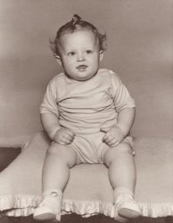 Alternately, a member of the lollipop guild. Randy Clevenger, 1950, previously seen here.
Doll!That curl makes him look like a Kewpie doll!
That Curl......took alot of maternal spit! It's interesting you would mention Kewpie Dolls, because my mom LOVES Kewpie Dolls...there's one sitting on a child's rocking chair in her living room right now!
(ShorpyBlog, Member Gallery)