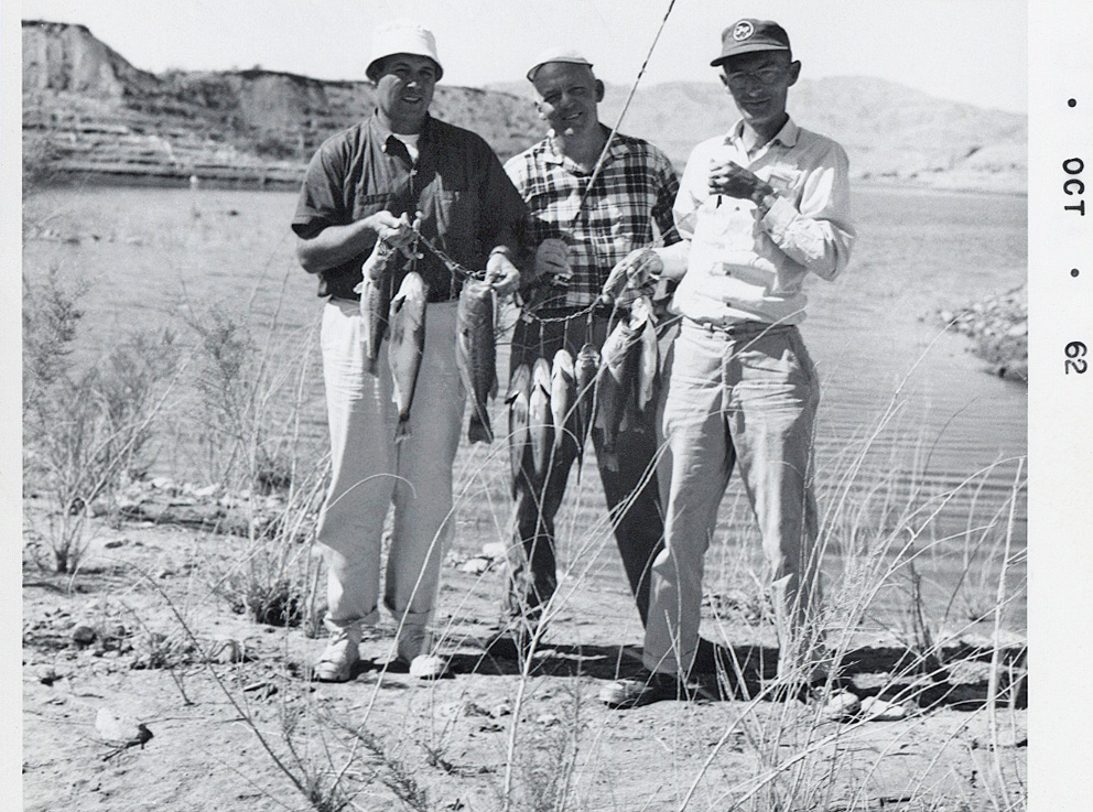 My dad, with the old 7-Up Little League cap on, is showing off their big bass catch at Lake Mead in the early 60's. My godfather Herb, who I was named after, is in the middle. View full size.