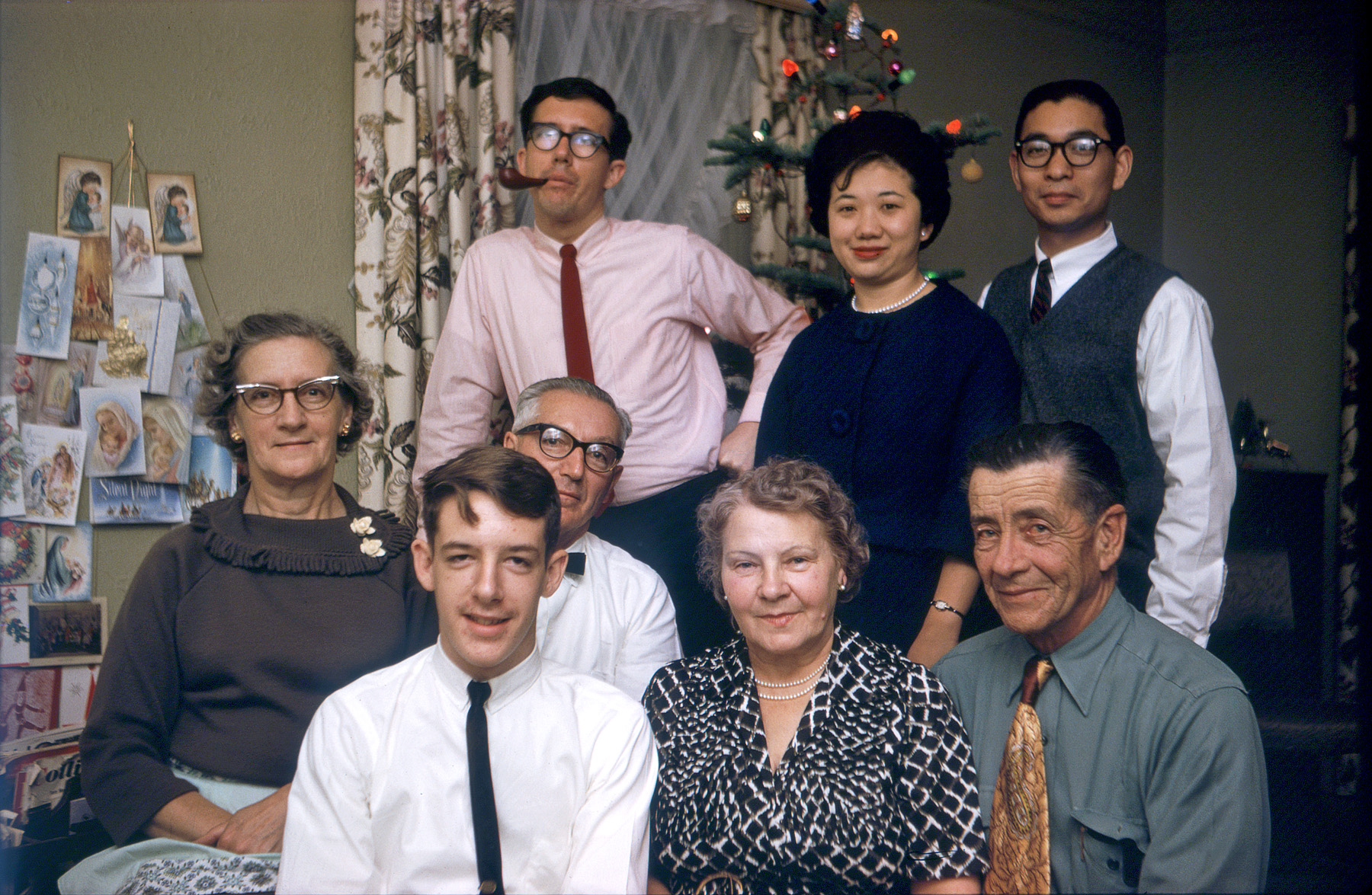 It's December 1962 and family and friends have gathered for a near-Christmas dinner. I've just gotten my first 35mm camera, a Kodak Retinette, and with the help of my trusty Kodak Master Photoguide, manage to ace this Kodachrome bounce-flash exposure. That's me, age 16, strategically positioned in front of my father, who's still in his supermarket work garb, so it's obviously not Christmas day. Next to me in front are Aunt Grace and Uncle Jack, my mother's oldest brother. At the time I probably thought his shirt/tie combo was corny, but now I love it. Mother's on the left looking pleased, perhaps because the serendipitous arrival of identical cards made for a pleasing symmetry in her card tree on the wall. In back, my brother and our friends Colleen and Bob. Bob had been my brother's Cal Poly college mate, and later lived with us a bit before marrying Colleen. View full size.