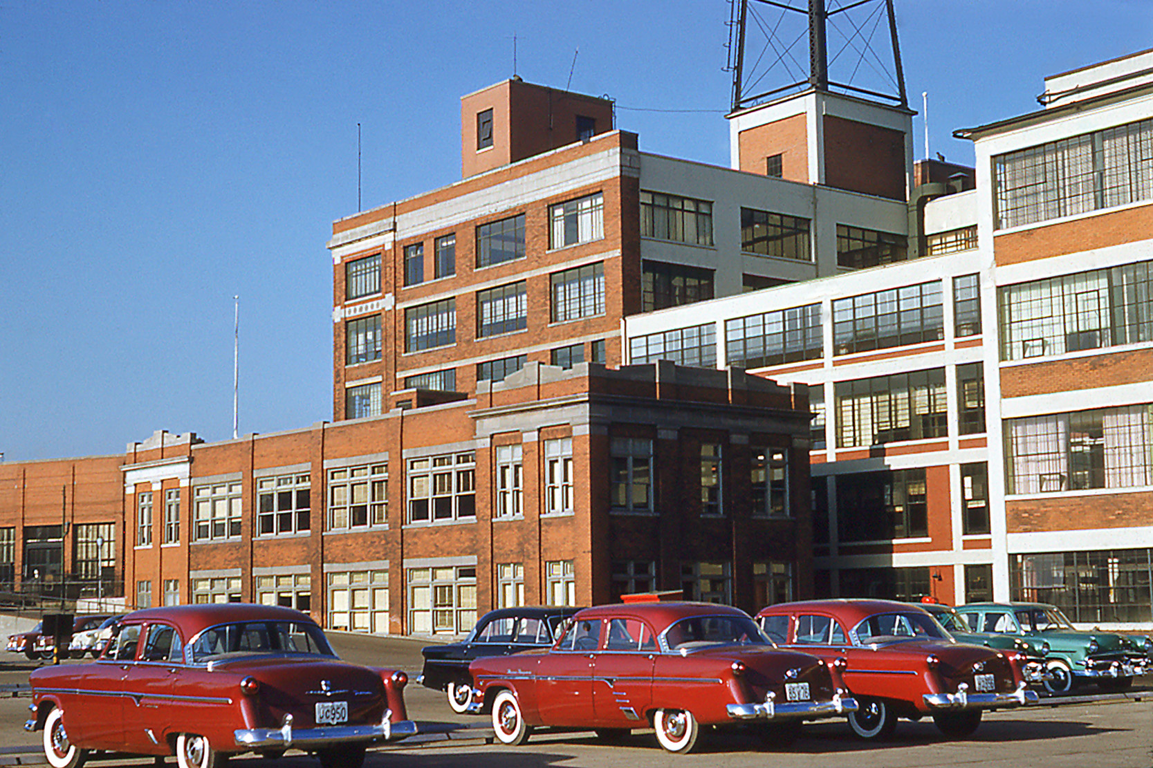 My father took this Kodachrome in Ford Plant 1 in Windsor, Ontario, in 1954. The history of Ford here goes back to 1904 when Model Bs and Cs, and later Model Ts, were built in this complex. The plant was located right alongside the Detroit River at Riverside Drive East and Drouillard Road. The two storey building in the foreground was built in 1912 as office space, and as Ford expanded more offices were installed in the buildings behind. This is where my father worked in management. To see a present day view click here. A photo by the Detroit Publishing Co. of this area in 1914 can be viewed here, and here is a story on the demolition in 1969. View full size.