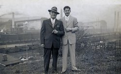 My grandfather and neighborhood boy in the Wilson section of Clairton, PA with steel mill in the background. Photograph was taken sometime in the late 50s. Given all the smoke belching out from the stacks everyone must have been working. 
My father grew up in here, just up the Monongahela from Pittsburgh. He did not return after getting out of the Marines in 1946. Every summer during the 50s and 60s we would drive up there from Beaufort, SC to visit family. I loved it. Nobody spoke English. Italian on one side of the river (Clairton) and Slovak on the other (my Mom folks lived in McKeesport). Kennywood Park, Forbes Field and the volcanic coke works at Clairton. I loved it and was willing to give up the beach, salt march and clean air for a chance to live in the dirty, smokey air of exotic Clairton. Thank god, this was not to be. View full size.
(ShorpyBlog, Member Gallery)