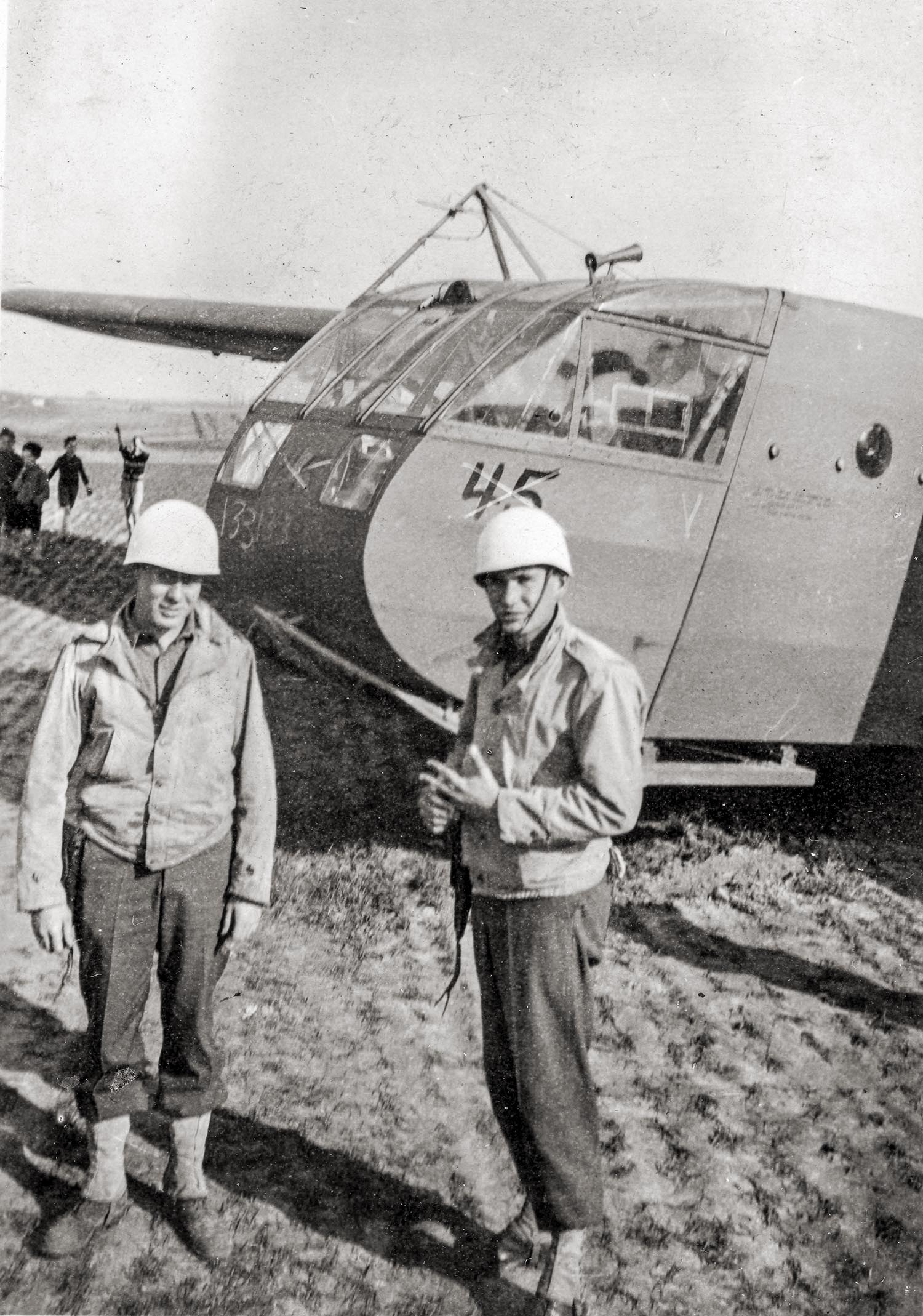 This is a found photo. Written on back: "March 1945. Dexter Nunley, T5 and myself on guard at a disabled glider that put down near our camp at Lasne-Chapelle - Saint Lambert, Belgium. No one injured."

Allied combat gliders were towed behind modified bombers or transport aircraft and used in some of the riskiest missions of World War II.

Lasne-Chapelle-Saint-Lambert in Province du Brabant Wallon (Wallonia) is a city located in Belgium about 13 miles south-east of Brussels, the country's capital. General Courtney Hodges' U.S. First Army liberated the region south of Brussels and Maastricht in early September 1944. On February 4, 1945, the country was reported to be free of German troops. Following liberation Belgian towns were widely targeted by unpiloted German V-Bombs, particularity centered on the Port of Antwerp. German crews fired more than 4,000 V-1s and more than 1,700 V-2s at greater Antwerp. Lasne-Chapelle-Saint-Lambert is located approximately 57 miles south of Antwerp.
