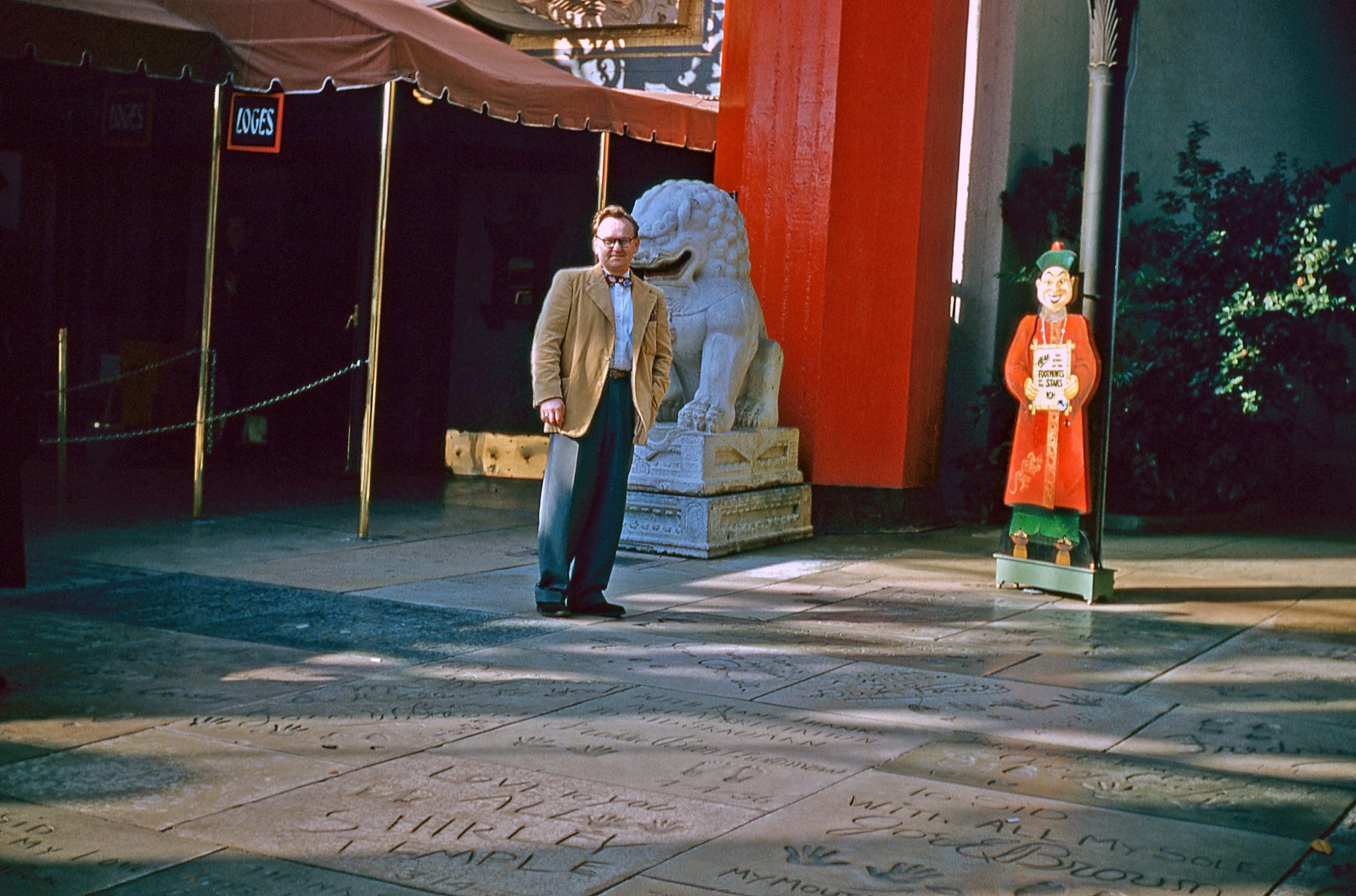 Forecourt of Grauman's Chinese Theater in Hollywood. Pristine footprints and a cutout caricature that wouldn't pass inspection today. Lucy and Ethel wouldn't steal John Wayne's footprints for another two years. A found slide. View full size.