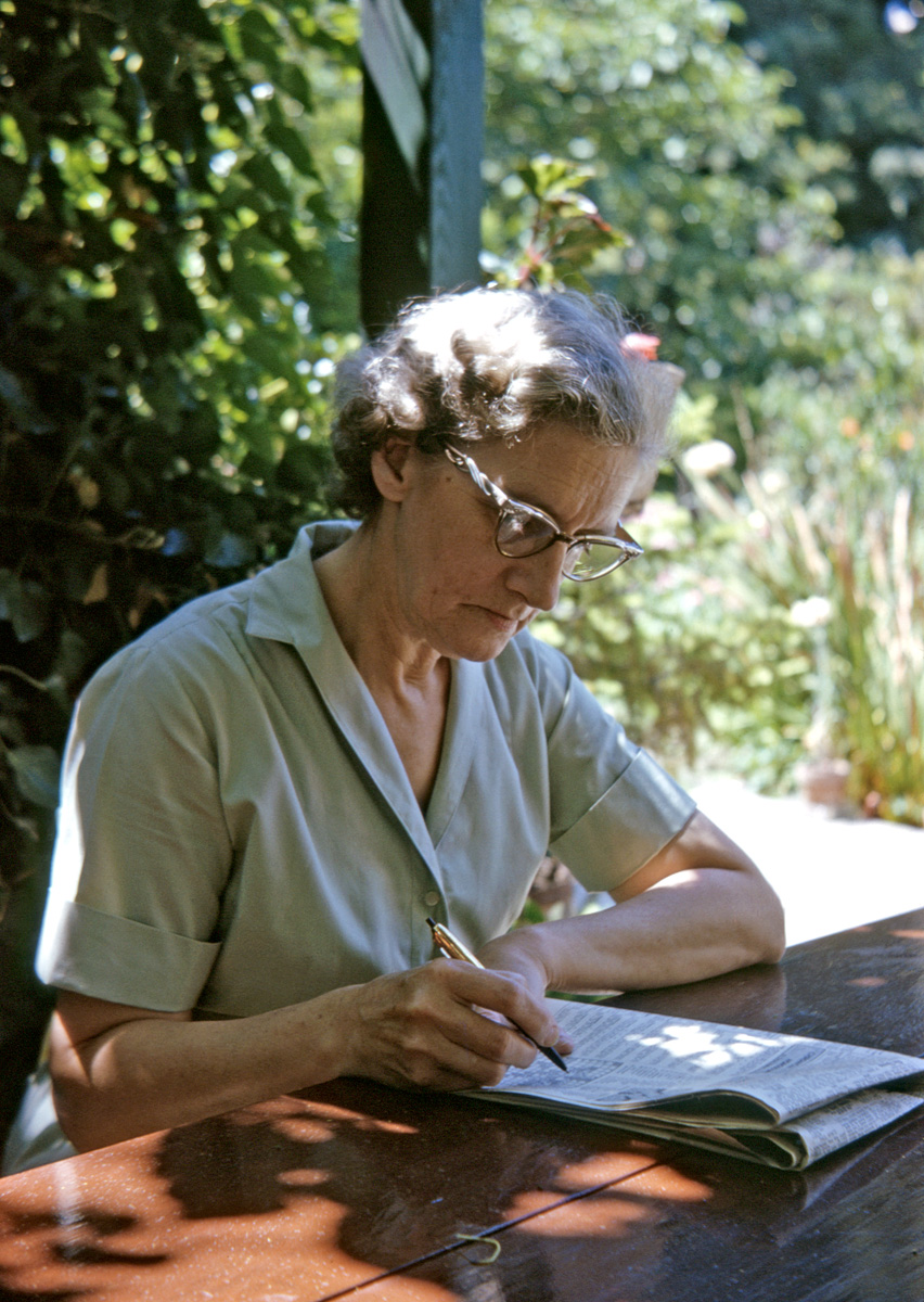 June 1963. My mother doing the crossword puzzle, seated under our grape arbor. Her glasses seem to have a fan base here on Shorpy, so here they are close-up. It's not posed, and I probably got a dirty look after she heard the shutter click. For chronological context, I was two months shy of 17 when I took this Kodachrome, and my mother 54. We were both Leos. View full size.