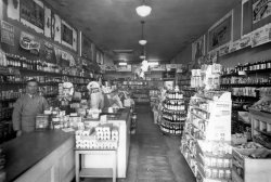 My father in his store, the De Luxe Groceteria, at 494 14th St. in San Francisco,  sometime during WWII circa 1947. This was a neighborhood grocery, but similar in size to the Skaggs Safeway stores he worked in and later managed in San Francisco during the 1920s-1930s. Here's a photo just after he opened in 1934.  View full size.
