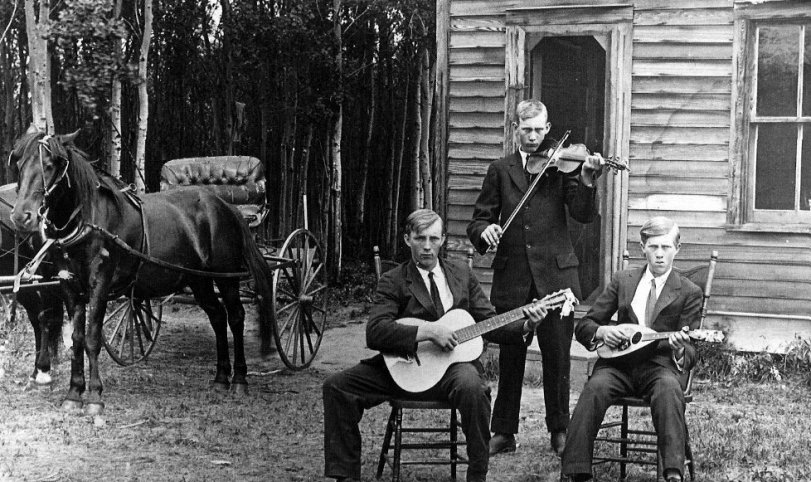 Taken on a rural Alberta homestead.  The musicians are brothers one of which is my grandfather.  Picture would have been taken in the late 1930's or early 1940's.