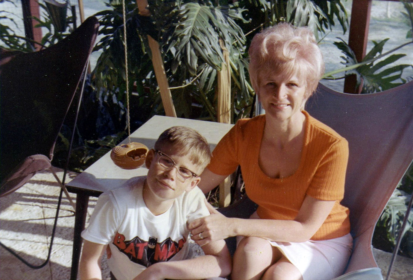 Here's a snap of my brother and my mom early in 1966. Check out the Batman t-shirt my brother's wearing (I believe the television show had just begun); his horn-rimmed glasses; my mom's mini-bouffant, and the butterfly chairs. To sum it all up, the whole pic really says "mid-1960s" to me. I hadn't been born yet, but I recall those chairs much later on, and my mother dyeing the faded covers in a vat of Rit. View full size.