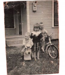 Approximately 1960 in Baytown, Texas. My sister Althea Racca and our brothers Faron Racca (bike) and James Racca (Huckleberry Hound).
A Faint Memory in TimeThanks, for the faint memory from so long ago in our lives my brother. Boy how it always amazed me that old Huck hung around to play with us for years to come. I remember you as a small boy playing with him in the early 70’s when we lived in Mableton, Georgia. 
(ShorpyBlog, Member Gallery)