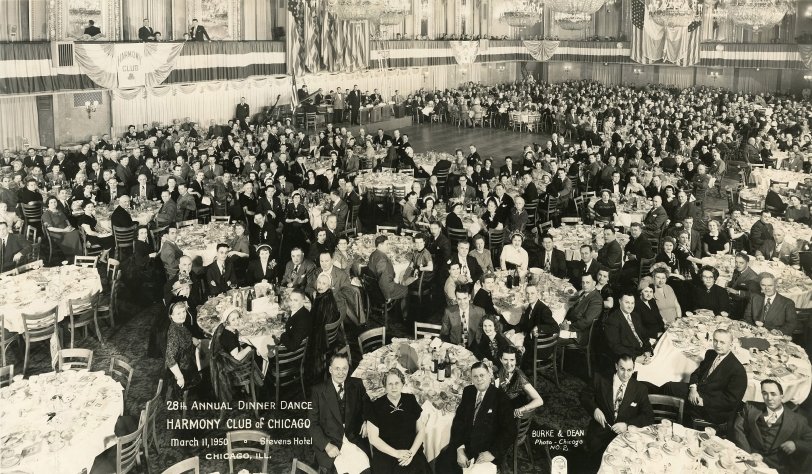 Harmony Club of Chicago, 28th Annual Dinner Dance, March 11,1950 at the Stevens Hotel, Chicago. Photo by Burke &amp; Dean Photo, Chicago. I did a little research and discovered that the Harmony Club of Chicago still exists and their mission is "to promote cooperation in the electrical trade." In particular, they are associated with IBEW Local 134.
This is a panoramic photo. I have been at similar events, and the way it works is: A photographer with a special camera comes in and offers to take a panoramic shot of the whole crowd, and he takes orders for copies afterwards.  He pans the camera across the crowd slowly and everyone tries to move as little as possible.  It takes several seconds to pan across the crowd. This is a scan of a 12x20 photo I bought in an antique store recently. View full size.
