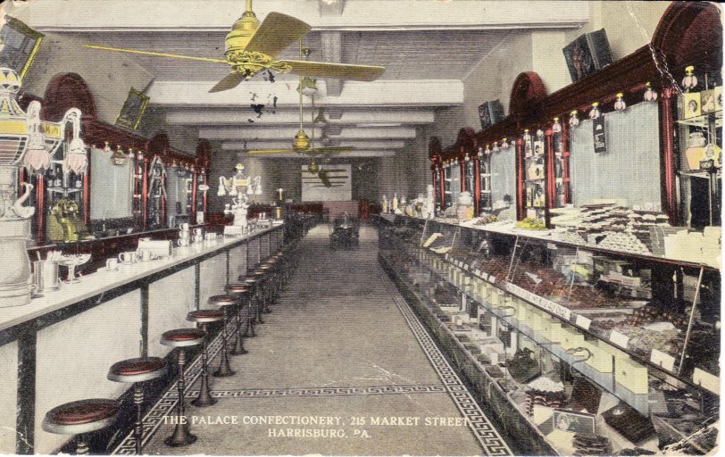 Color tinted postcard showing interior of The Palace Confectionery in Harrisburg PA. Postmark date is 1914 (still has 1 cent stamp attached). The approximate location would have been across the street from The Whitaker Center, where Harrisburg University stands. View full size.
