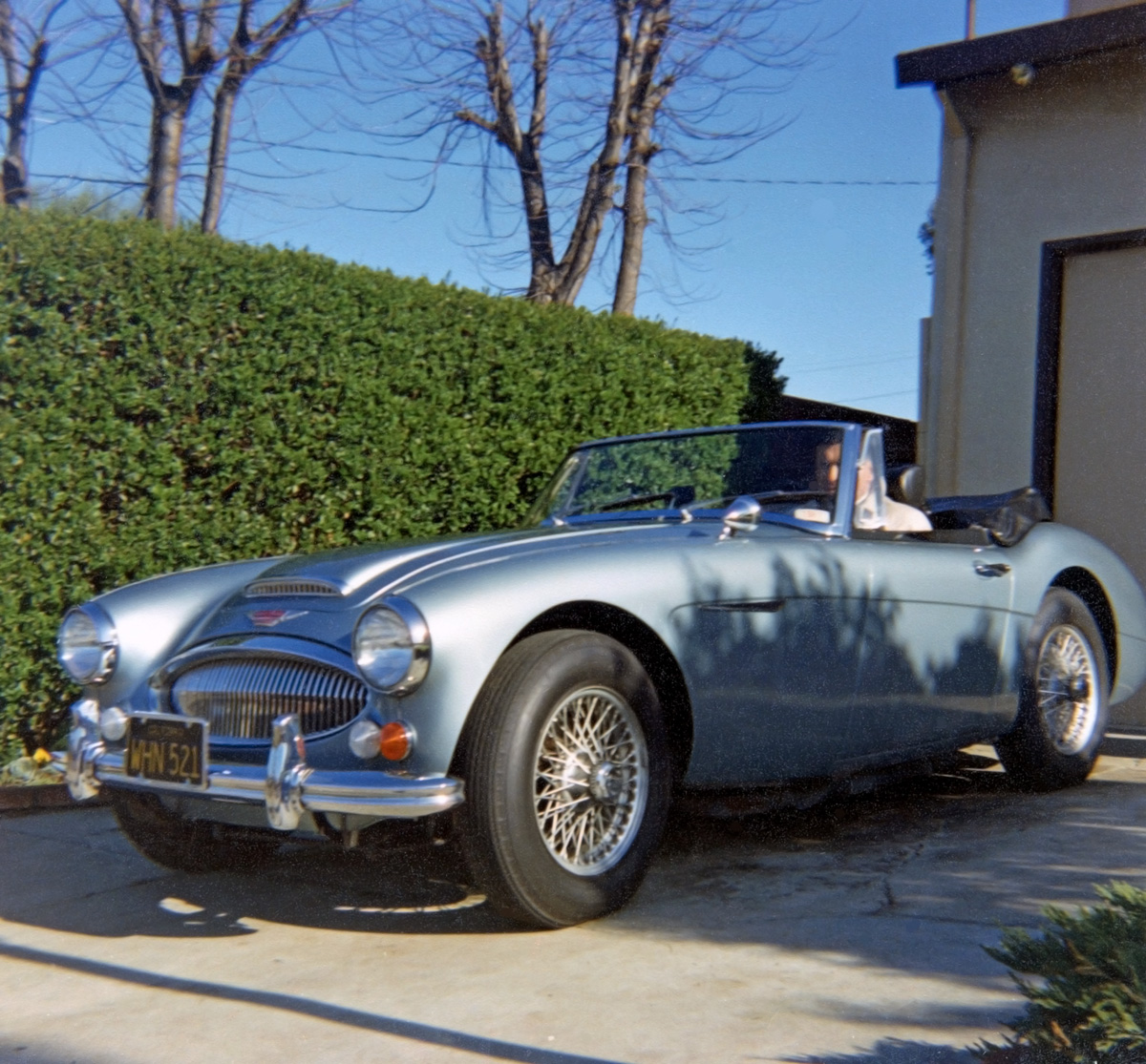 Another photo of my dad with his new '67 Austin Healey 3000 in early 1968. He was a newspaper reporter and he has his "Murrow" London Fog trench coat on for the chilly top-down morning drive to Oakland (S.F. Bay Area). He made a small sticker with a label maker (remember those?) that said, "Disraeli Rides Again!" and it was applied on the inside of the glove box door. View full size.