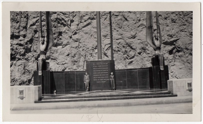 Two unidentified tourists pose like statues in the dedication plaza of Hoover Dam. View full size.
