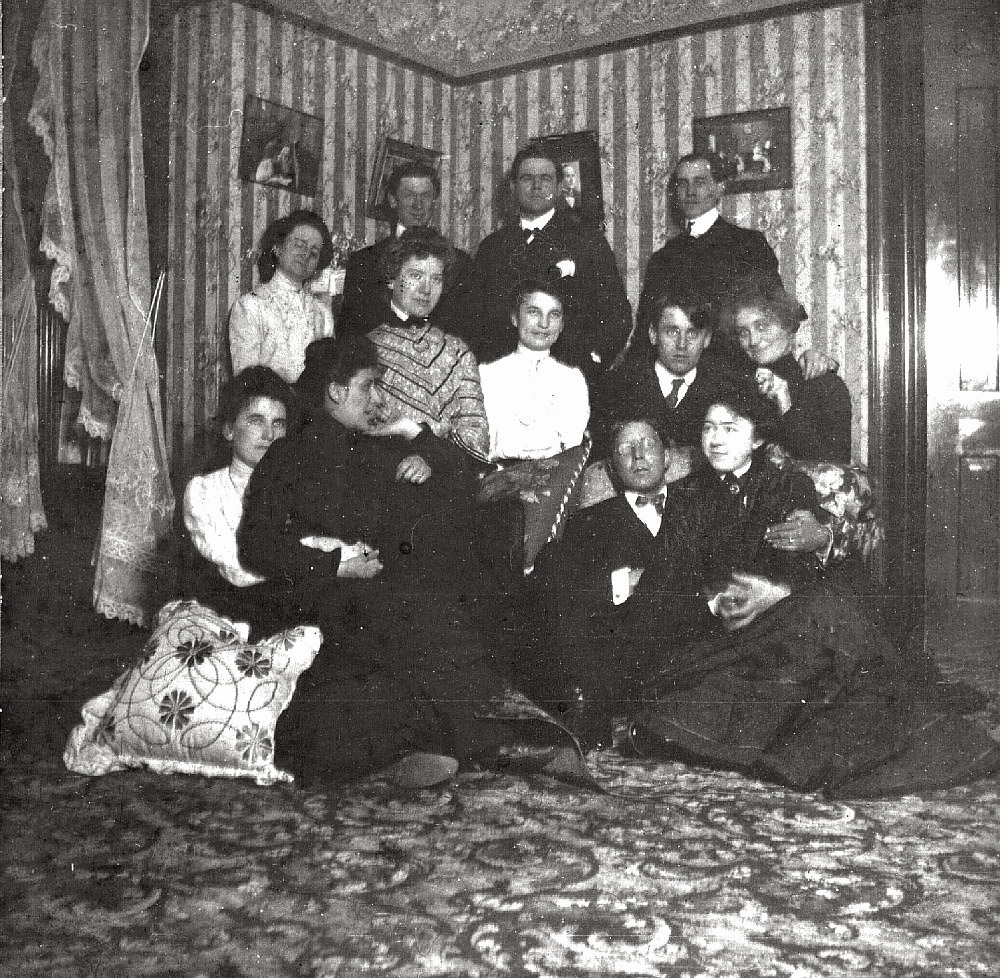 A large group fits into a tight corner for this late-19th/early-20th century shot.