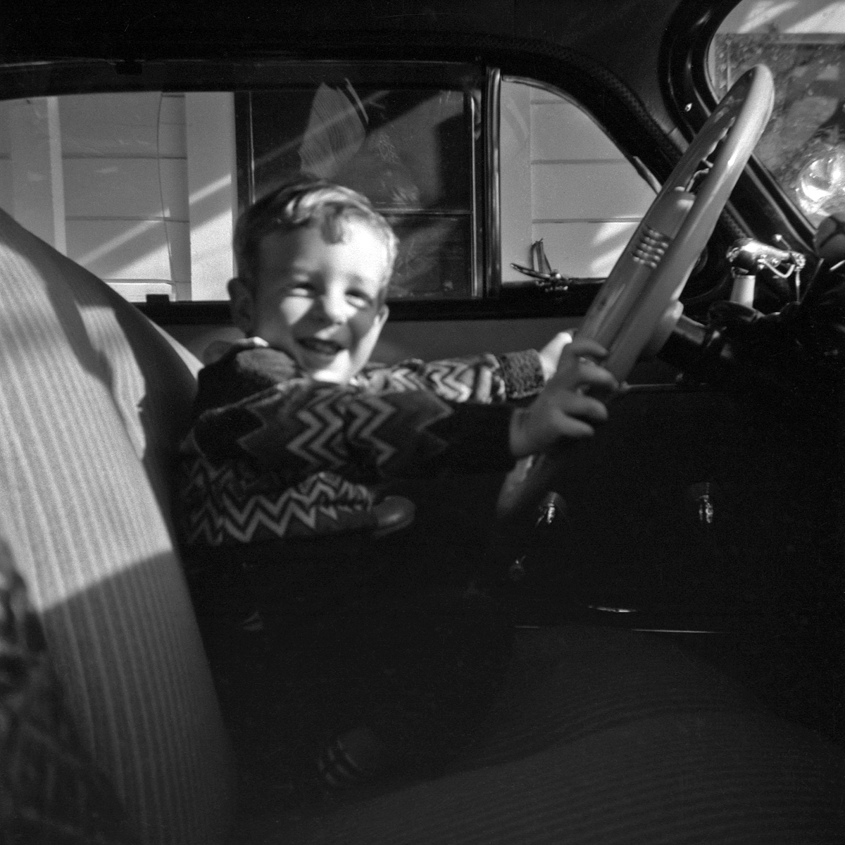 Here I am at the wheel of the 1948 Hudson posted earlier. I figure I'm about three here, which would make it around 1949-50.
