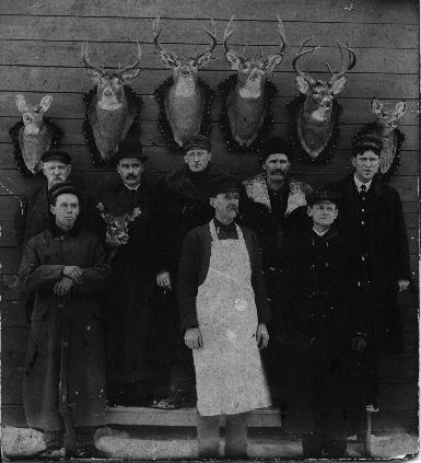 Eight men and seven deer about 1895 in Hanover, Michigan.

Back Row Left to Right
1.Wells W. Dew (b.1848, d.1933)
2.Bill Preston
3.Barney Ramsdell 
4.George Buell
5.A.B.Sanderson (Albert Edwin Thompson Sanderson, b.1867, d.1921)

Front Row Left to Right
1.Ralph Sanderson (b.1874, d.1957)
2.Will H. Sanderson, Jr. (b.1852, d.1933)
3.Doc. Hathaway (medical doctor in Hanover, Michigan)

Ralph and A.B Sanderson are cousins.  Will Sanderson is the father of Ralph and uncle to A.B. Sanderson.
Ralph Sanderson is the youngest in the photo. I estimate he is about 20 years old, so the photo was taken about 1894/1895.  There are 8 men in the photo and 7 deer.  All the men lived in Hanover, Michigan.  It could have been taken in Hanover or a northern Michigan deer camp.

I wonder if Will Sanderson was the butcher?  Look at the cigar in the hand of Barney Ramsdell.  The men all appear to have long hunting coats.  Four of the men appear to have white shirts and ties.

A.B. Sanderson is my Great Grandfather on my father's side of the family.  Sandersons and Levys still live in the Hanover area.  William H. Sanderson, Sr.  and his wife Electa Bentley purchased a farm in the town of Somerset  in 1844, which they improved and made for themselves a home. In 1865,  they moved to Hanover and remained there for the rest of their lives. William H. and Electa Sanderson were parents to Will H. Sanderson Jr.