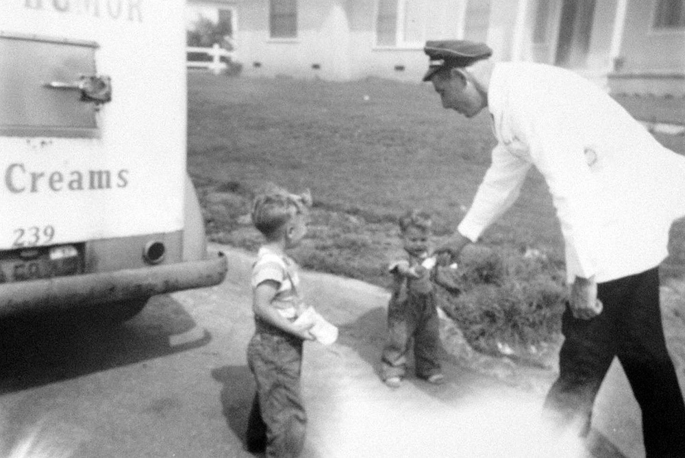 Glenn and Mike Herbert receiving their ice cream from the well dressed Good Humor man. West Covina, California 1950. Photo by Mary Herbert.