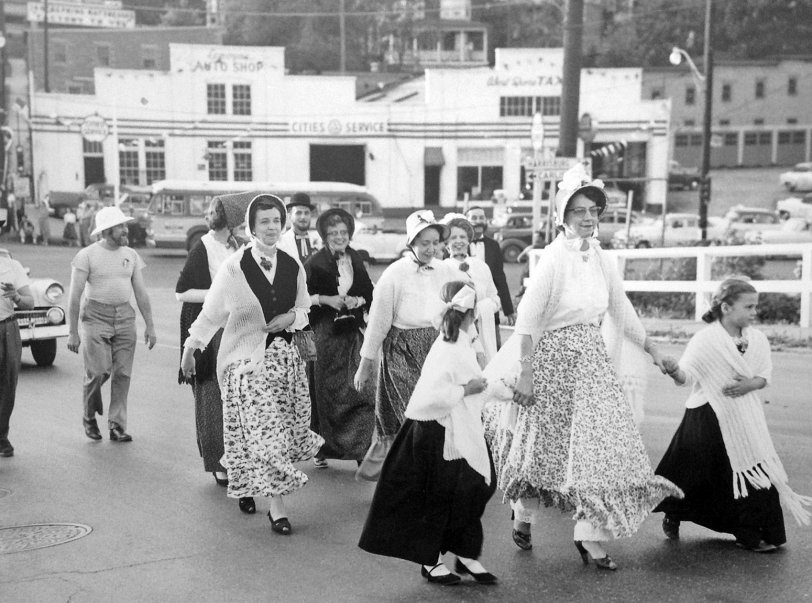 Founders Day parade as captured in Lemoyne, Pennsylvania on May 17, 1955. My grandmother is in the photo, with black headdress and sweater. Looks as though they have the traffic tied up until they clear the intersection. Years later I walked across that same bridge when visiting and loved it as under the 3rd Street Bridge the newer Penn Central Railroad lines ran, replacing the old Pennsylvania Railroad from which my grandfather ran until retirement. View full size.
