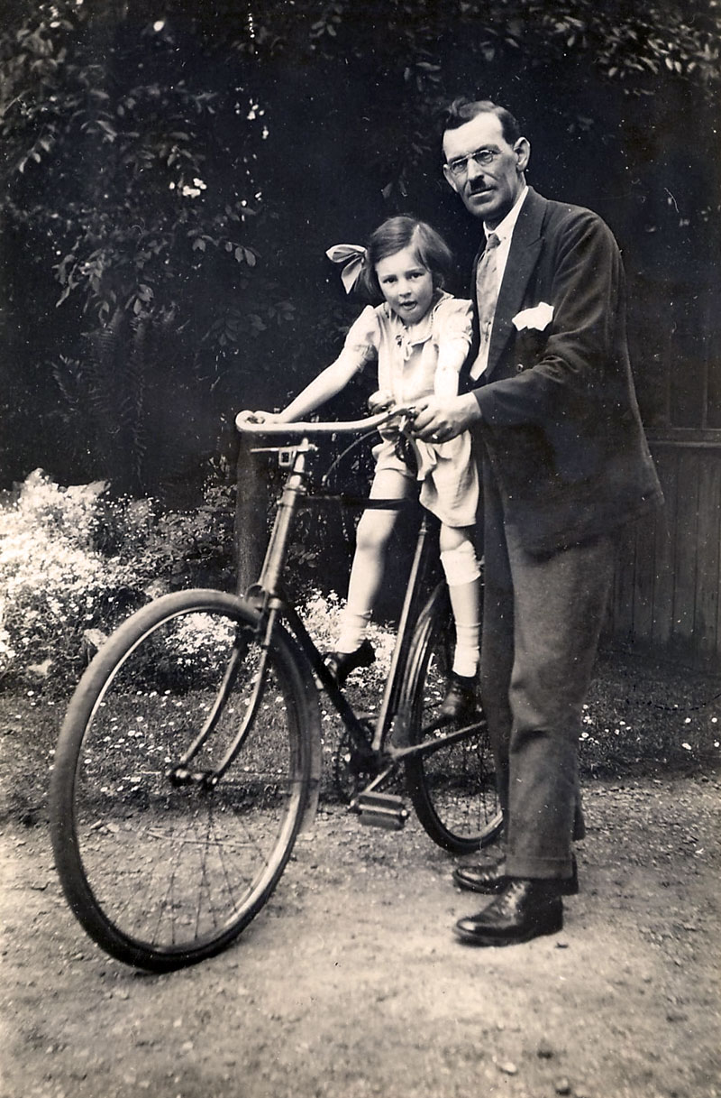 My mother tries out my grandfather's bicycle for size, around 1929. The photo was at my mother's insistence. My grandfather sports the popular mustache of the day, "The Toothbrush". Heaven knows why it was so popular. Mother appears to have already skinned her knee. View full size.