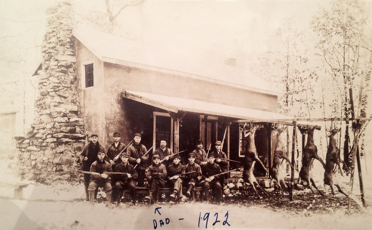 Picture taken of a hunting cabin in 1922. More than likely located somewhere in the wilderness of Pennsylvania. That would be my great grandfather in the picture. My grandmother's writing across the picture. View full size.