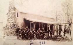Picture taken of a hunting cabin in 1922. More than likely located somewhere in the wilderness of Pennsylvania. That would be my great grandfather in the picture. My grandmother's writing across the picture. View full size.
(ShorpyBlog, Member Gallery)
