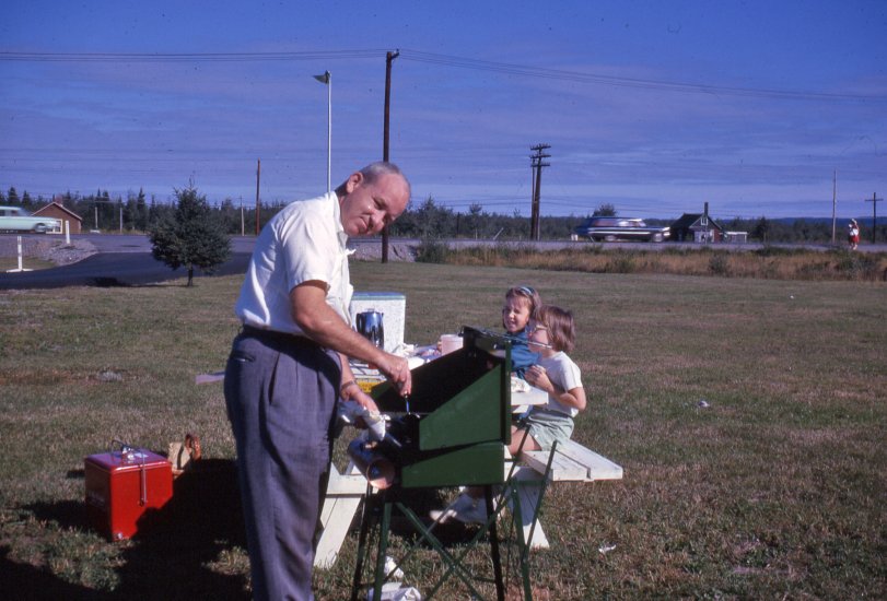 This is how you pull over for a family meal during a road trip. It's the early 60's and the family is off to visit Canada. Kodachrome slide. That camp stove used white gas.  View full size.
