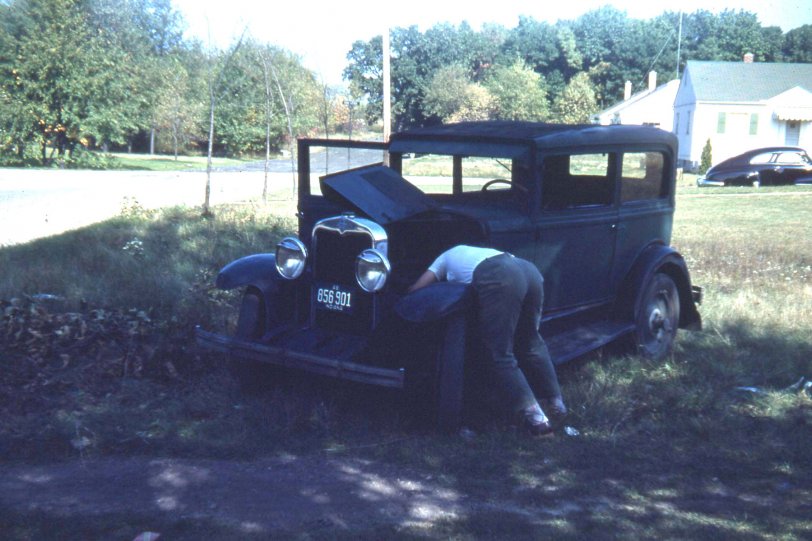 1940's in Valparaiso, Indiana.  Dad's working on his first car that he bought for $25.  I think this is after the war but I'm sure the gearheads among us can tell us the earliest possible year based on the car in the background.  The title refers to what my uncle wrote on the slide index.  He was more forthcoming with the comedy than he was with dates.  From a Kodachrome slide that was too dark so to get the car to show up I adjusted the heck out of the levels in Photoshop.  Sorry the background colors seemed to suffer a bit.  
