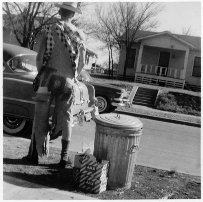 I don't know who this is, but liked the picture a lot. Taken in front of our home on Hondo Street in Dallas. Although the print says it was developed in January 1956, I'm thinking Halloween party, October 1955. I see Jax beer boxes and what looks like a 1954 Pontiac. View full size.
