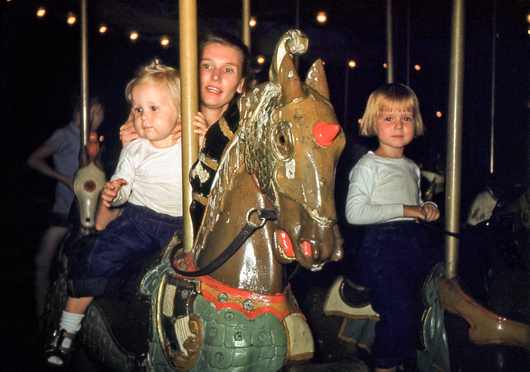 This is my mom, Dorothy Porter, and my two older sisters, Madge and June, on a family vacation trip to Folly Beach, South Carolina in the summer of 1950.  Not sure if the old carousel was at Folly Beach or if this was perhaps taken at the Myrtle Beach Pavilion. 35mm Kodachrome slide. View full size.