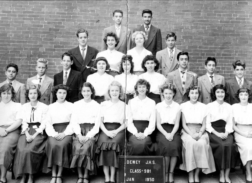 My classmates' graduation photo. Taken at Dewey JHS 136 school yard, in January 1950. Located at 40th Street and 4th Avenue in the Sunset Park section of Brooklyn NY.
Recently using the internet and telephone, I was able to locate 5 of my classmates. We are all in our mid 70's. Together we arranged a reunion. Over 50 years had passed. It was wonderful to meet and see each other again. Later I found this photo and emailed it to them. Together we were able to remember the names of all our classmates, and most of our teachers. We still communicate via email and telephone. View full size.
