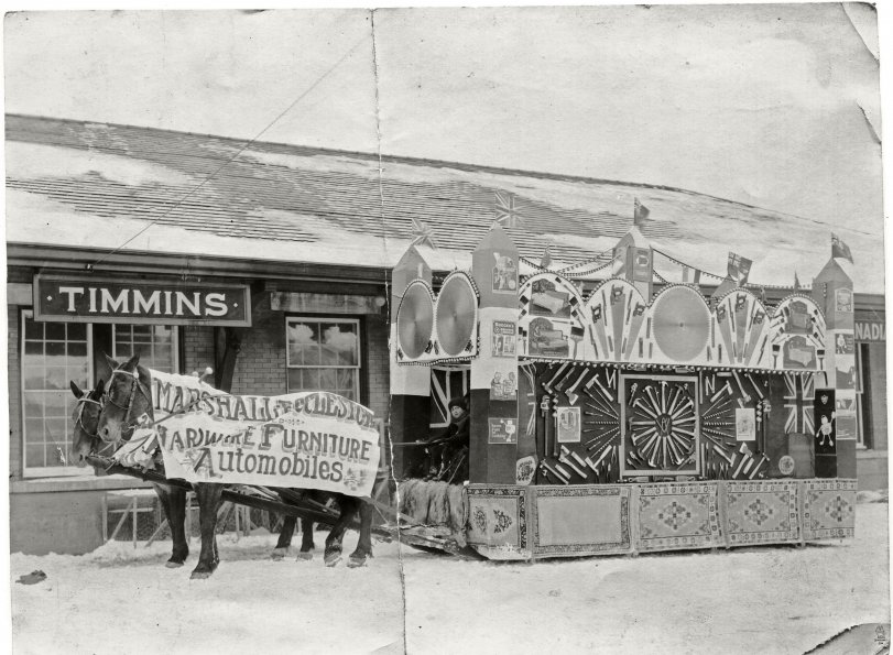 Horse-drawn Marshall-Ecclestone Furniture & Hardware store parade float in front of the Timmins, Ontario, railroad depot.

Grandfather worked at the store as a young man and likely had a hand in constructing this display of the variety of tools and supplies available there.

Similar photos in the collection are dated 1927.
