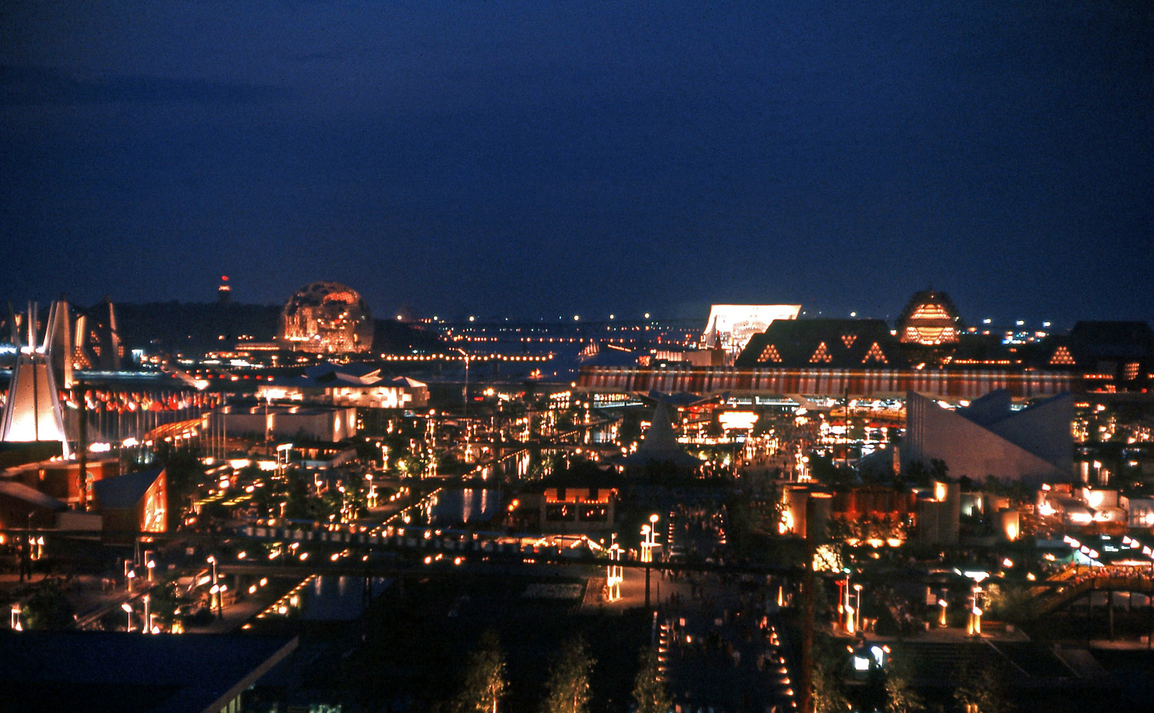 Montreal, 1967. This shot was taken using 35mm Kodachrome with the camera resting on a railing. In the distance, the U.S. pavilion is the Buckminster Fuller dome on the left while the U.S.S.R. pavilion is the brightly-lit dipping roof building on the right. Today, the U.S. pavilion still stands as an indoor arboretum. View full size.