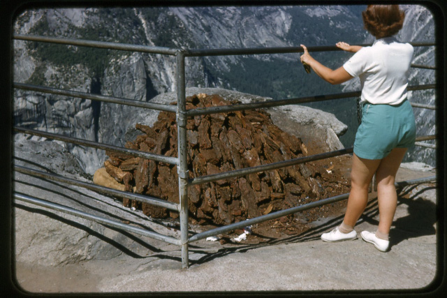 Pile of bark that will later in the afternoon be set afire with the coals from the fire being pushed over the side just after the sun had gone down to create the famous Yosemite National Park Fire Fall.

Photo taken in 1956 using a Nikon S 35mm camera with a 135mm lens and Kodachrome film.

Name of person in photo is unknown. View full size.
