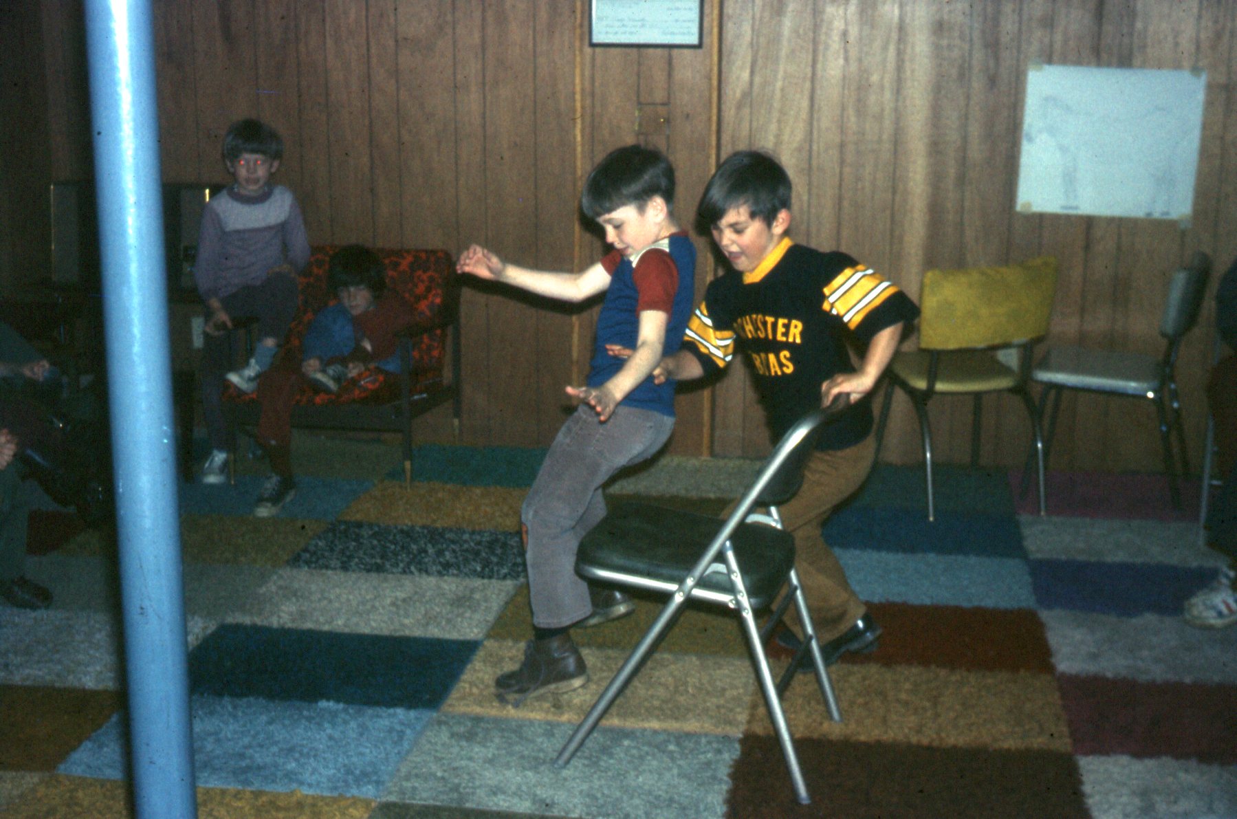 Two of my friends go for gold in the basement in Rochester, Indiana around 1974 for my birthday party.  Mom made the wall-to-wall carpeting out of rug samples.  