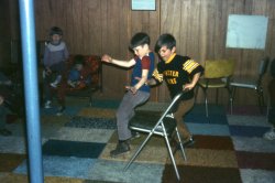 Two of my friends go for gold in the basement in Rochester, Indiana around 1974 for my birthday party.  Mom made the wall-to-wall carpeting out of rug samples.  
That RugYikes, my parents did the same patchwork quilt rug job in my childhood bedroom!
The Rug Again...We had the same carpet-sample floor in our entire basement in Ohio. And in our tiny 13' travel trailer. 
I thought my mother invented it. Maybe not...
(ShorpyBlog, Member Gallery)