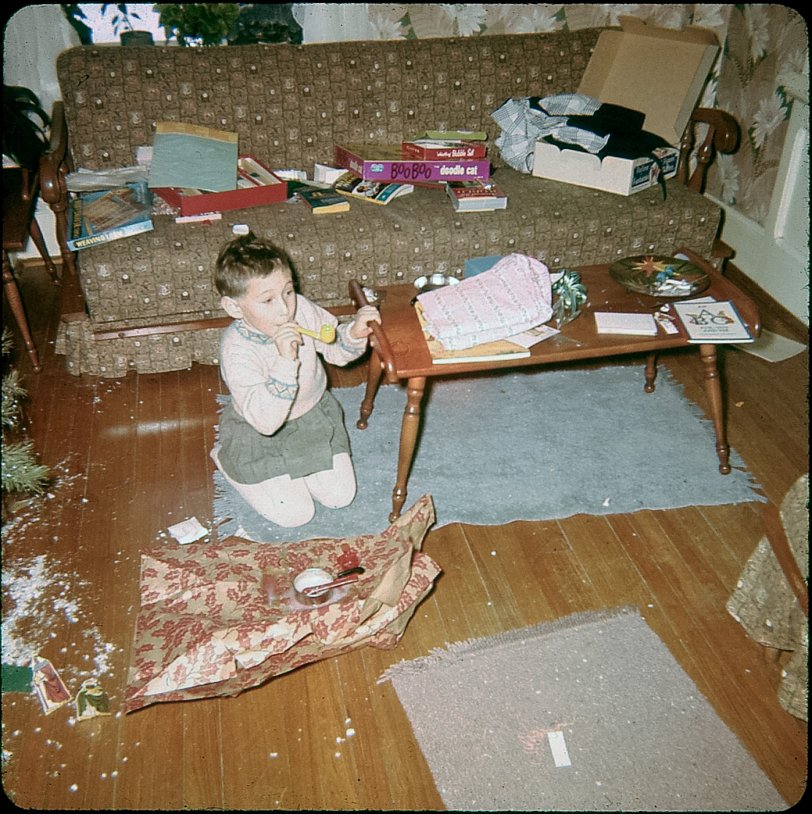 Christmas morning aftermath. I recognise the loom on the sofa but the other boxes are a mystery. Don't recall them at all.
I just found a large box of slides and negatives last week. This was one of the ones I haven't seen in years. There's also a photo taken the next summer with the bubble pipe. I'll post it as well. View full size.
