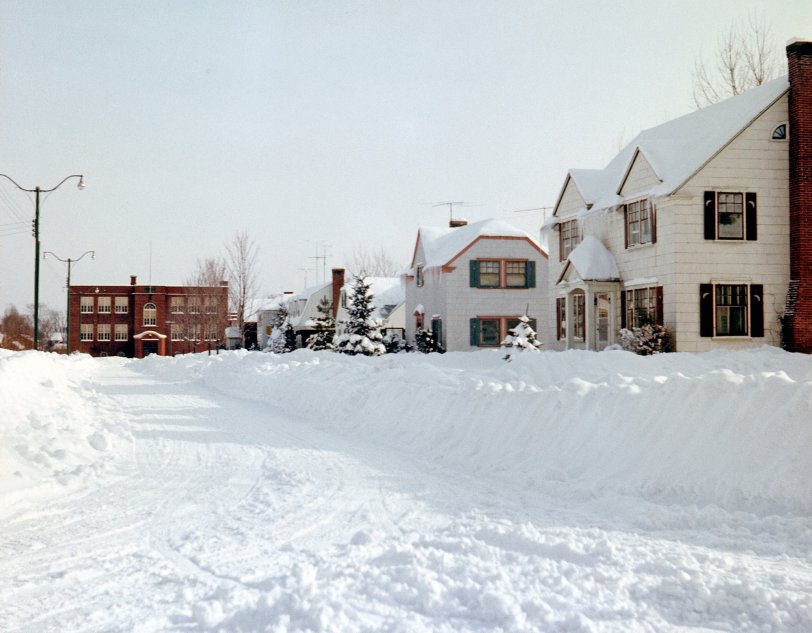Bedford, Quebec in the grip of winter, circa 1957. This is looking down Victory Blvd., with Bedford High School at the head of the street, where I attended from Grade 1 to Grade 5. As is apparent from this picture, there was lots of snow in late 50s Quebec Eastern Townships winters. View full size.

