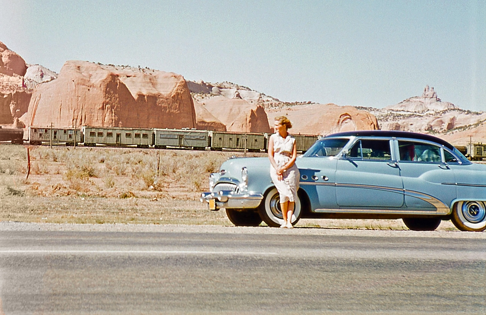 On the road back to California from Florida, May 28, 1956. Cropped left side of image as it had the "end of roll" light leak. I'll bet the train was long enough for my dad to stop the car, get out the camera and have my mom pose. View full size.