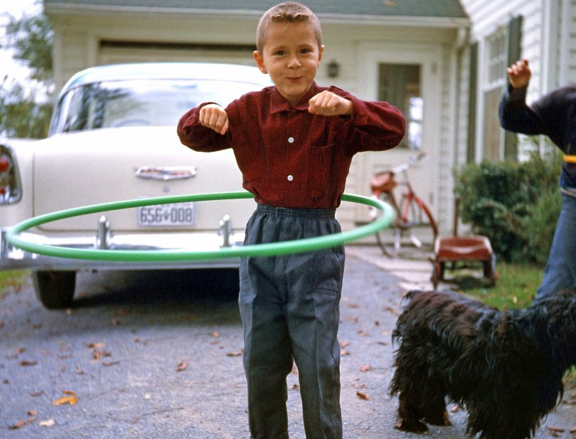 This is me in the summer of 1958 in Bedford Quebec, during that year's Hula Hoop craze. As you can see, Mom sure did dress me in a weird way -- buttoned-up collar, full cuffs and elastic band pants? Our cocker spaniel Cindy is in the background. View full size.
